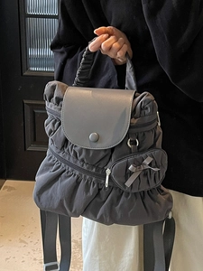 Dark grey pleated nylon backpack with cloud effect and decorative bow detail