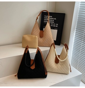 Detail of woven tote bags with rope handles and leather accents in modern minimalist style
