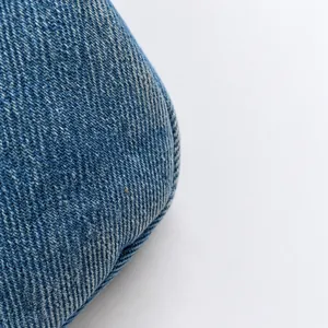 Detailed macro view of high quality blue washed denim fabric with distinct diagonal texture