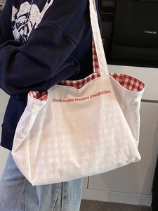 Minimalist large canvas tote bag with red checkered lining and inspirational text