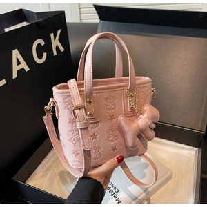 Détails du sac cabas rose gaufré avec ferrures dorées et breloque chiot mignonne