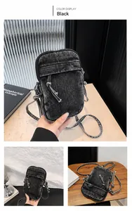 Detail view of black washed denim crossbody bag with drawstring pocket and zipper
