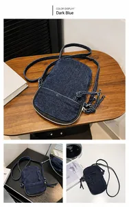 Detailed views of a dark blue washed denim crossbody phone bag with zipper pockets