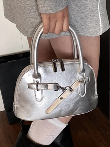 Chic silver metallic shell handbag with top handles and industrial metal buckle detail