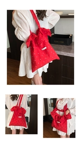 Close-up of red polka dot mesh tote with ruffled chiffon texture and Magic pocket label
