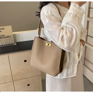 Litchi pattern leather bucket bag with gold twist lock on shoulder for commuting