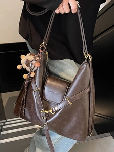 Brown vintage faux leather hobo tote bag with adjustable straps and plush bear charm