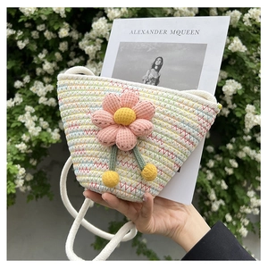 Close-up of handmade woven bucket bag featuring a pink sunflower and white rope strap