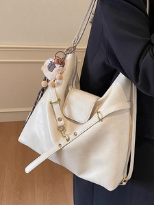 Large cream white tote bag in soft PU leather featuring a plush charm for daily commuting