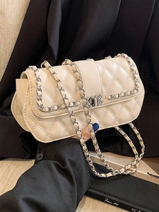 Elegant cream quilted crossbody bag with silver metal chain strap and flap closure