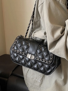 Elegant black quilted leather crossbody bag with chain strap and metal swivel lock
