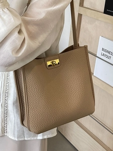 Chic light brown lychee grain bucket bag with gold twist lock and slim shoulder strap