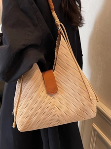 Minimalist beige woven tote bag with V-shaped chevron pattern and rope shoulder straps