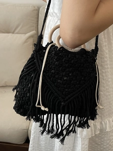 Bohemian black woven hand bag with wooden circular handles and fringe tassels