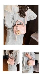 Pink mini pillow bag with bear charm and adjustable shoulder strap detail view