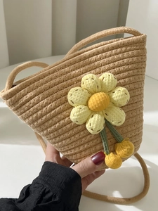 Cute straw bucket crossbody bag featuring a large yellow sunflower and woven strap