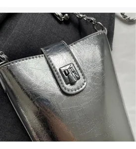 Detailed close-up of metallic silver bucket bag with ripple texture and chain strap