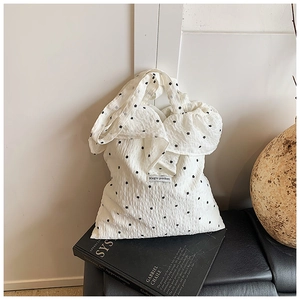 Close-up of Magic pocket label on a white floral chiffon tote bag with ruffles