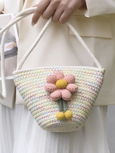 Cute woven flower bucket bag with colorful wavy patterns and soft white braided shoulder strap