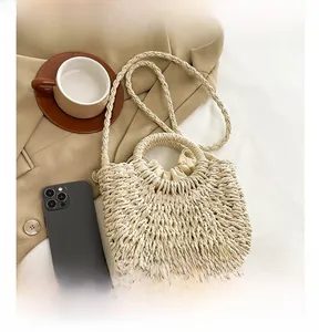 Straw basket bag featuring drawstring lining and detachable woven crossbody strap