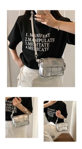 Detail view of silver woven crossbody bag with pearl handle and metal strap