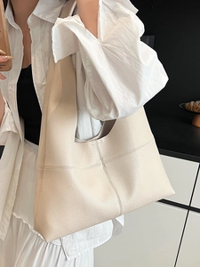 Chic cream leather hobo tote bag with cross-stitch detail and large capacity shown on model