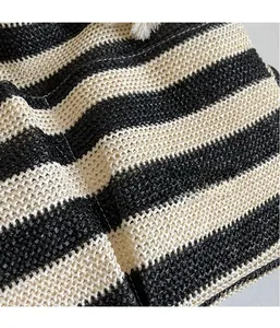 Close-up of the black and white woven fabric texture on a large capacity tote bag