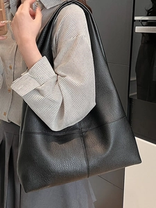 Minimalist large black leather tote bag with lychee texture and cross-stitch detail