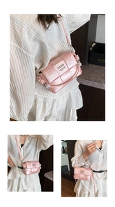Detail of light pink woven crossbody bag with beads on strap and metal logo