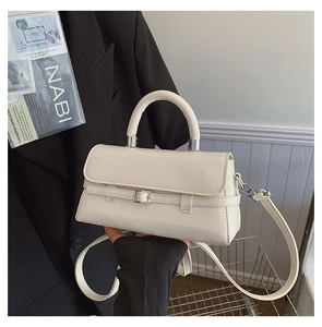 Detailed view of cream white crossbody bag with silver hardware and smooth faux leather finish