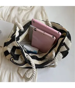 Spacious interior of striped woven tote bag showing large capacity and zipper closure