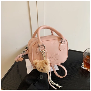 Pink PU leather pillow bag with cute plush bear charm and fashion logo embossed details