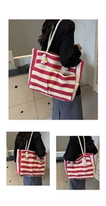 Detail of red and white striped woven tote bag with soft cotton rope tassel handles