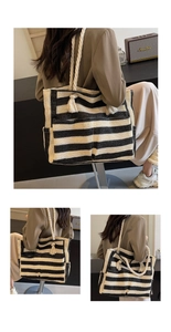 Detail of striped woven tote bag with thick rope handles and fringe on the side