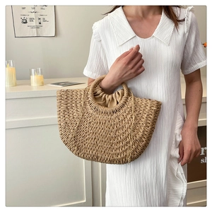 Detail of hand-woven straw tote bag with ring handle and drawstring lining for beach style
