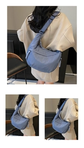 Detail of blue nylon dumpling bag featuring woven rope zipper and wide shoulder strap