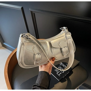 Silver metallic Y2K shoulder bag featuring dual buckle pockets and sleek leather texture