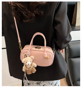 Pink Boston handbag with cute teddy bear charm shown from a stylish back perspective