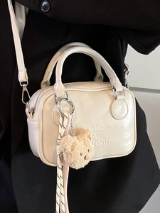 Minimalist cream white pillow bag with glossy leather and cute bear charm for women