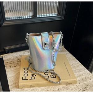 Macro shot of colorful holographic bucket bag with metal chain strap and twist lock detail