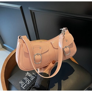 Detail view of pink glossy underarm bag featuring dual pockets with silver metal buckles
