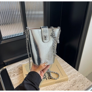 Close-up of silver mini bucket bag featuring metallic pleated texture and chain strap