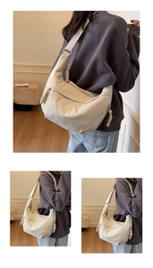 Detail view of cream dumpling crossbody bag featuring woven rope zipper and adjustable strap