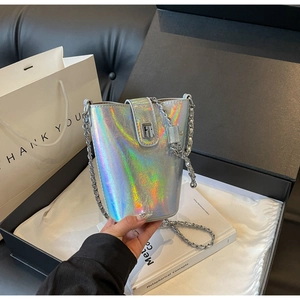 Close-up of holographic silver bucket bag with chain strap and metal swivel lock