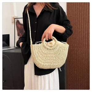 Detail of hand-woven straw tote bag with round handle and drawstring lining for summer holidays