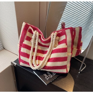 Detail of red and white striped woven tote bag with thick cotton rope handles