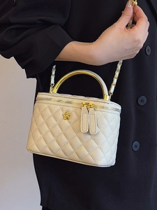 Elegant beige quilted box bag with golden camellia logo and metal chain strap