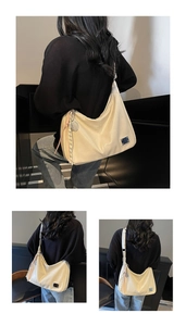 Detail of the cream-colored hobo shoulder bag with metal logo and woven rope charm