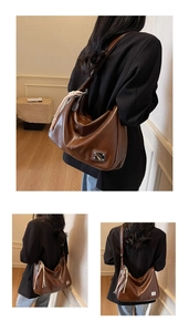 Detail of a large dark brown faux leather tote bag with silk scarf and logo tag