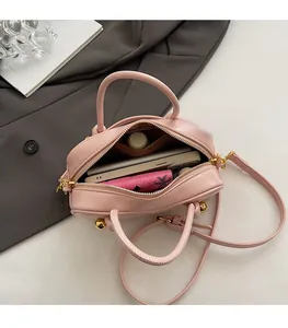 Detailed interior view of pink Boston bag showing spacious compartment for daily essentials